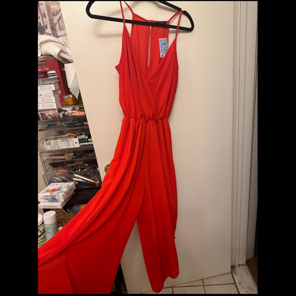 Brand new red jumpsuit. Slits on front of legs. Size small